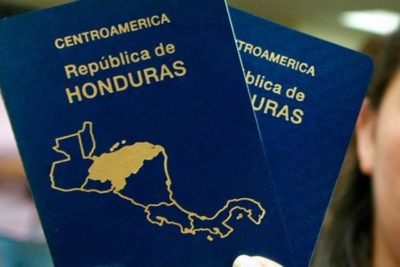 mujer sosteniendo pasaportes hondurenos