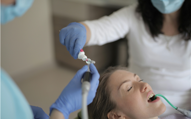 mujer hispana trabajando como asistente dental 